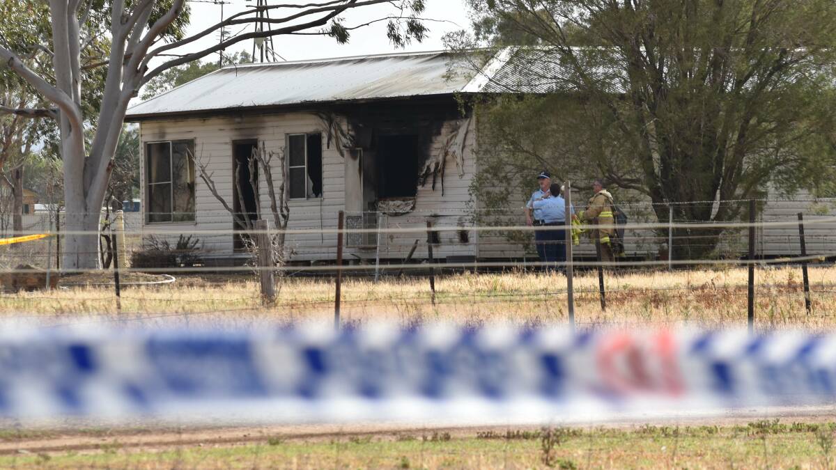 Crime scene: Police and fire crews at the Bylong Road home in Tamworth on Thursday morning. Photo: Ben Jaffrey