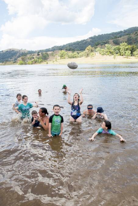Child's play: A group of locals were all smiles as they cooled off in Chaffey Dam near Nundle for Christmas. Photo: Peter Hardin