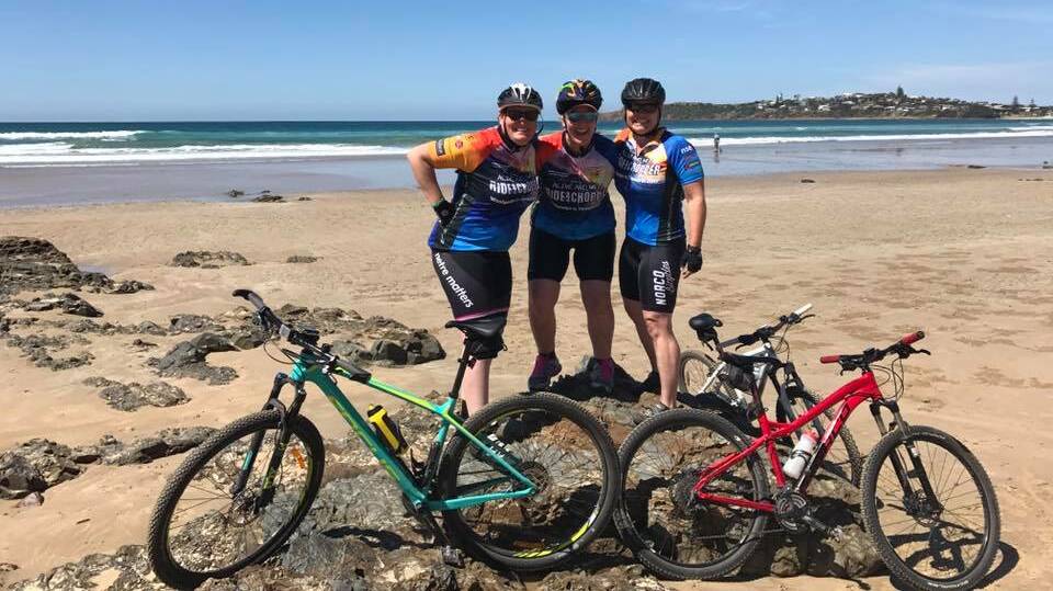 Coastal life: Sarah Wylie from Tamworth, Kirsty Speed from Sydney, and Kentucky's Amy Bell felt the sand between their toes in Woolgoolga.