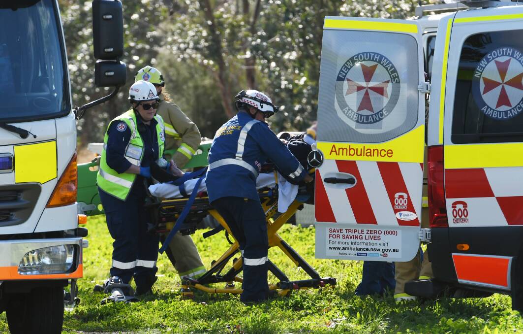 Rescue mission: Emergency services work to free the elderly driver in the crash on the Oxley Highway in Tamworth on Wednesday afternoon. Photos: Gareth Gardner