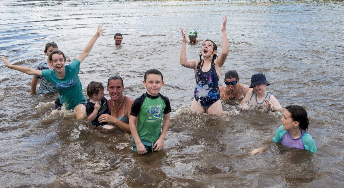 Child's play: A group of locals were all smiles as they cooled off in Chaffey Dam near Nundle for Christmas. Photo: Peter Hardin