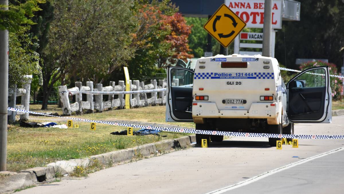 Crime scene: The injured officers were treated at the back of the police vehicle, which was cordoned off by police on Saturday, out the front of the house. Photo: Andrew Messenger