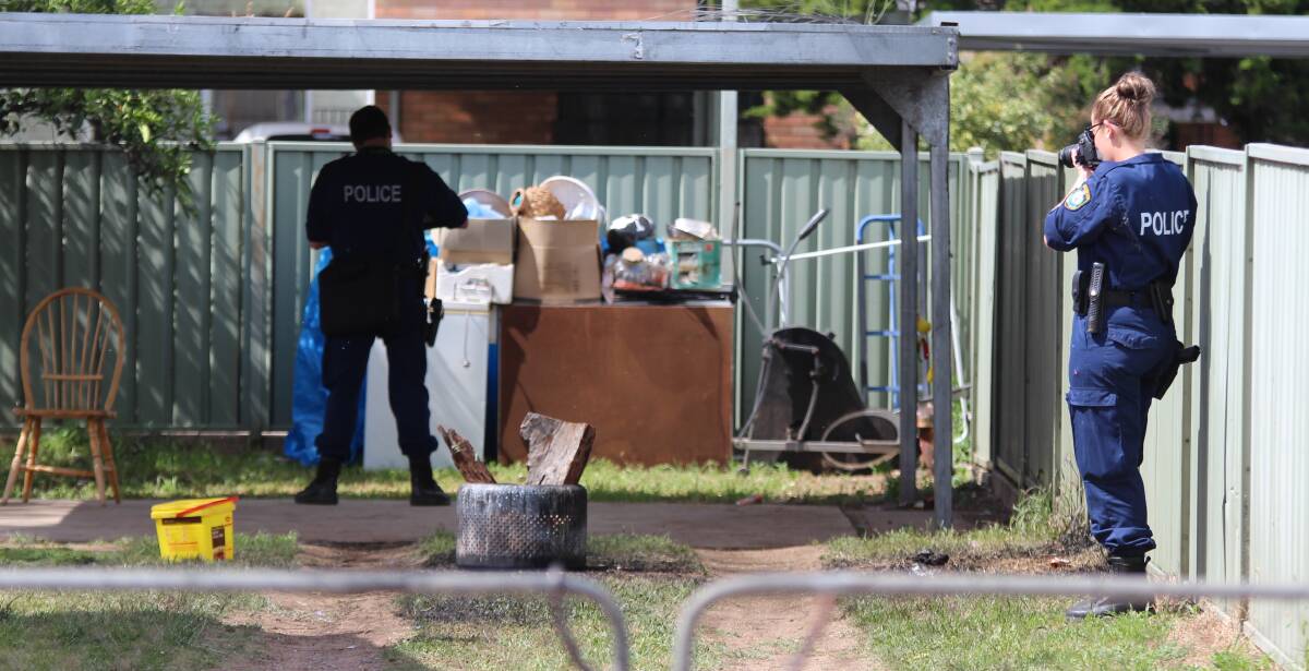 Crime scene: Forensic officers comb the backyard of a Little Barber St property where the explosion occurred on November 6. Photo: Sam Woods