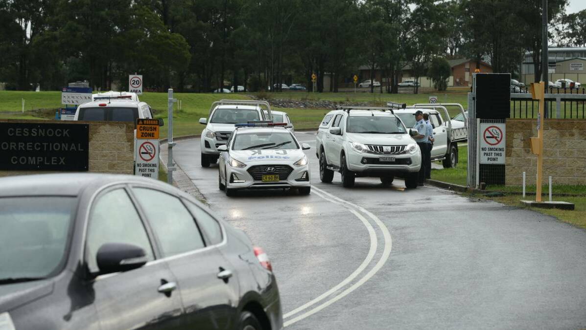 Charges in court: Police outside Cessnock Correctional Centre on the day of the riot in April.Twenty one men have been charged with rioting, participating in a criminal group and damaging property. Picture: Jonathan Carroll