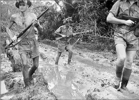 MUD AND SLUDGE: Members of the 61st Battalion at Milne Bay in October 1942. The photo illustrates the difficult conditions the infantry endured. Photo: Supplied