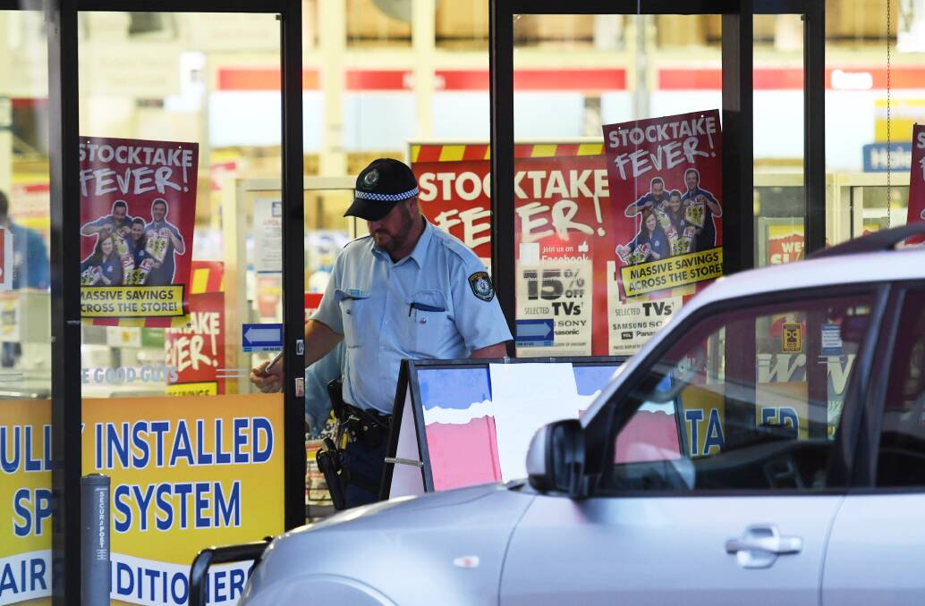 Crime scene: Police and detectives at the store in the Longyard area. Photos: Gareth Gardner