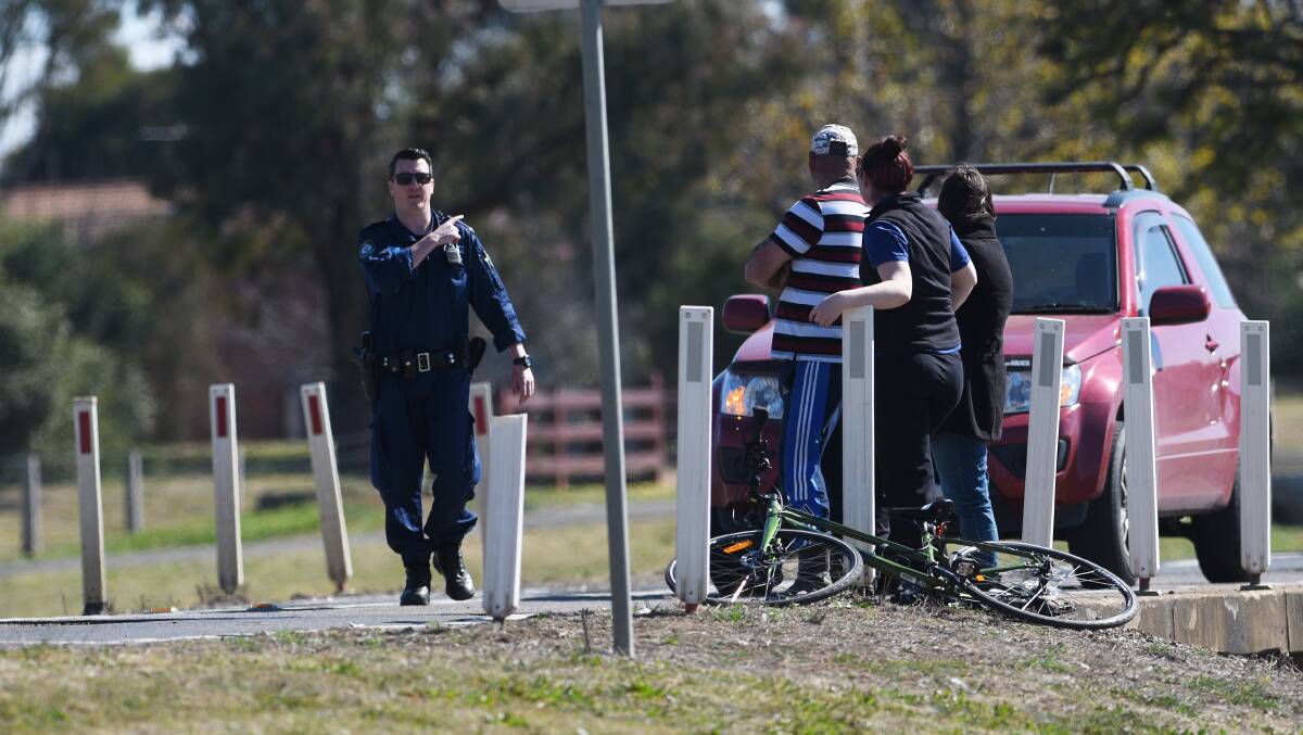 Crash scene: A police officer and witnesses at the site on the Oxley Highway at Westdale on August 29. Photo: Gareth Gardner