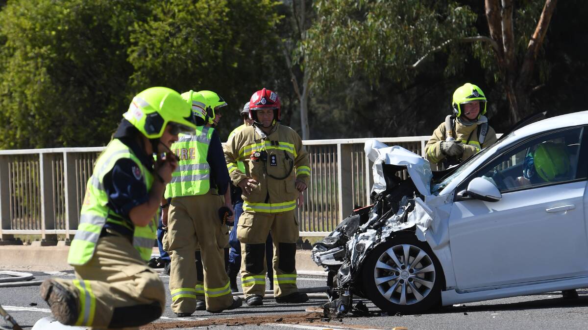 Crash scene: Emergency services with the wreckages on Scott Road on Friday. Photo: Gareth Gardner