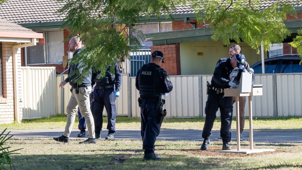 Police comb the crime scene in and around Susanne Street and Woodward Avenue in Tamworth on Monday. Pictures by Peter Hardin