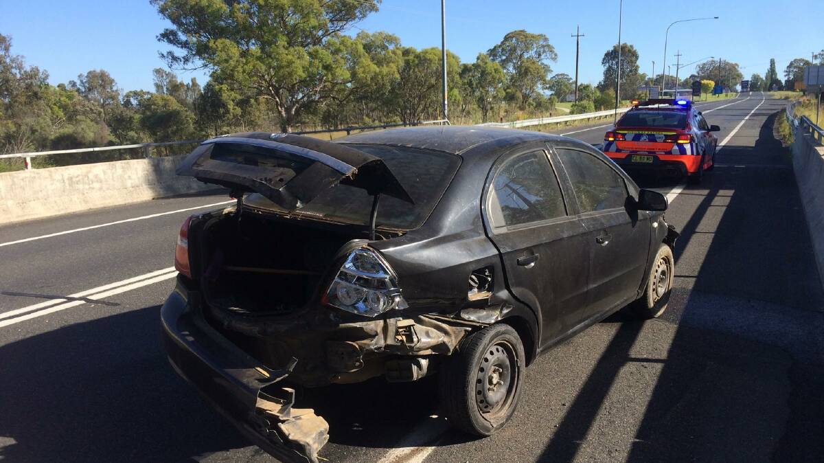 Raft of charges: The Holden Barina after it crashed trying to avoid road spikes on the New England Highway at Tenterfield on New Year's Eve. Photo: NSW Police