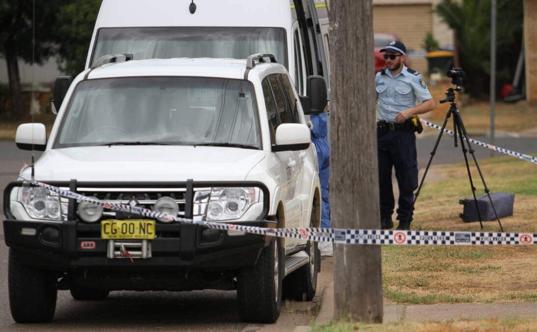Cordoned off: Police at the Coorong Street house on Sunday. Photo: Billy Jupp