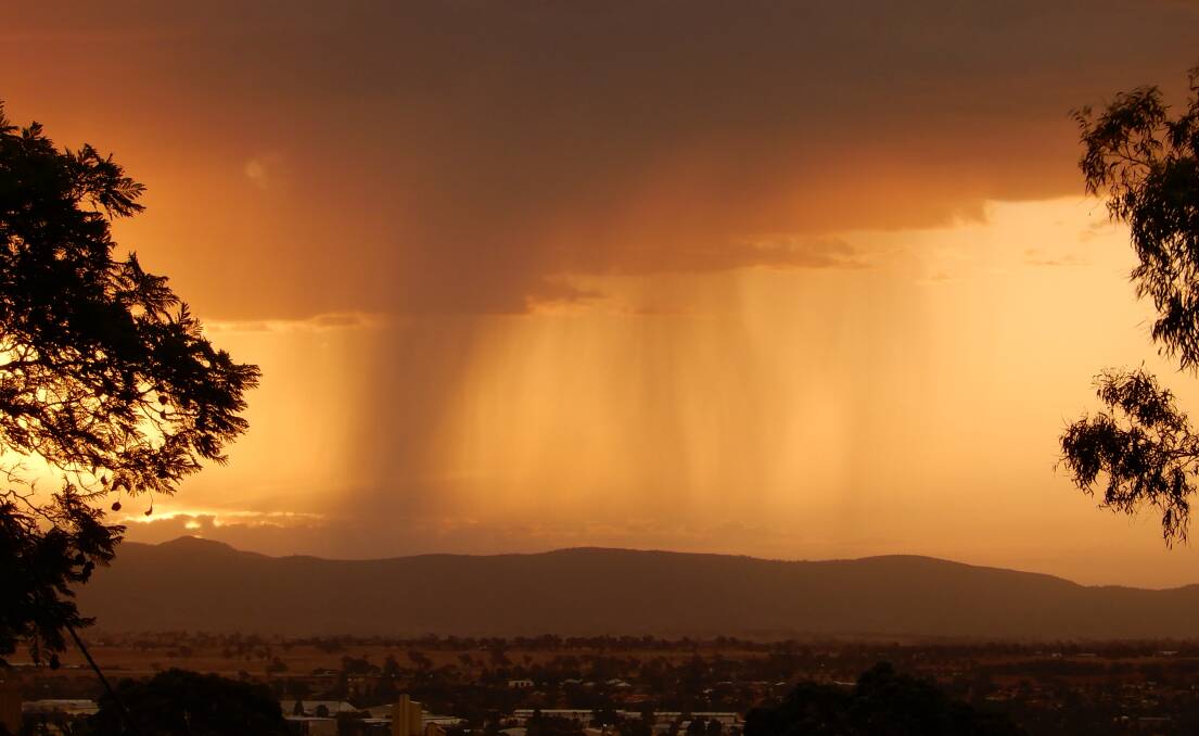 The rain falls over Tamworth during Wednesday night's short-lived storm. The city officially recorded 3mm of rain. Photo: Gaye Johnson