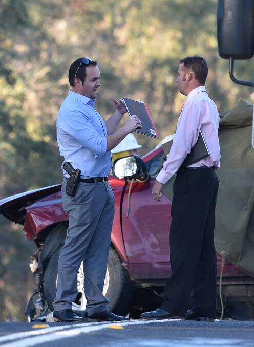 HIGHWAY HORROR: New England detectives at the scene of the head-on collision south of Uralla, which killed two men, including a UNE student. Photo: Gareth Gardner