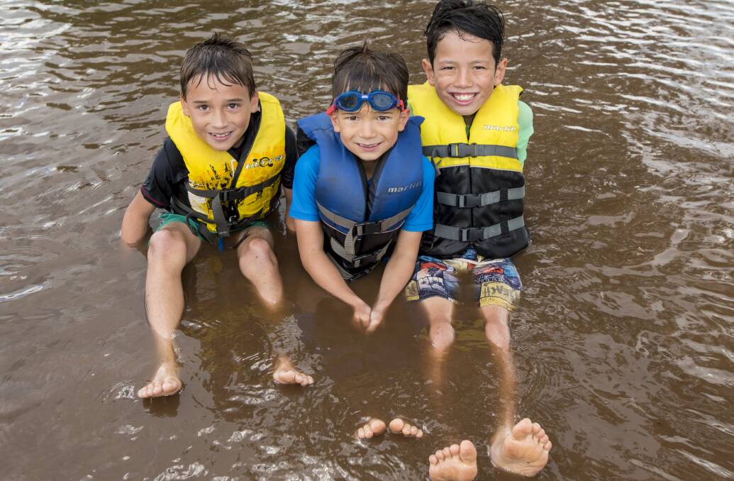 Getting wet: From left to right, Caleb, Daniel and Isaac Seaton cool off in the sun in Chaffey Dam. 