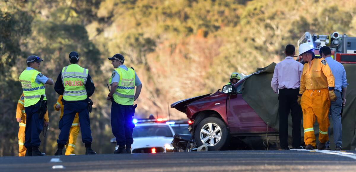 HIGHWAY HORROR: Police and New England detectives at the scene of the head-on collision south of Uralla, which killed two men, including a UNE student. Photo: Gareth Gardner
