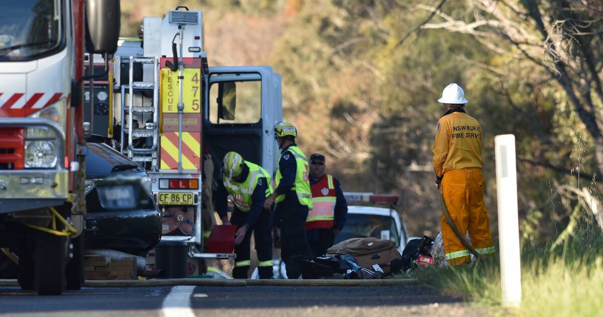 HIGHWAY HORROR:Emergency services at the scene of the head-on collision south of Uralla which killed two men, including a UNE student. Photo: Gareth Gardner
