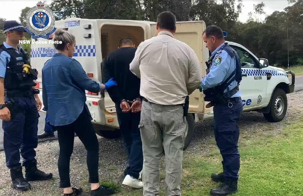 Under arrest: Detectives take Christopher James Levy into custody in Glen Innes in October 2020. Photo: NSW Police