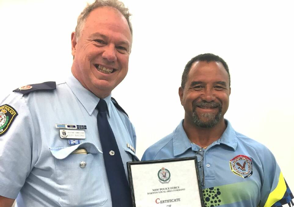 Round of applause: Assistant Commissioner Geoff McKechnie presents Willie Middleton with a certificate of appreciation after 21 years of service. Photo: NSW Police