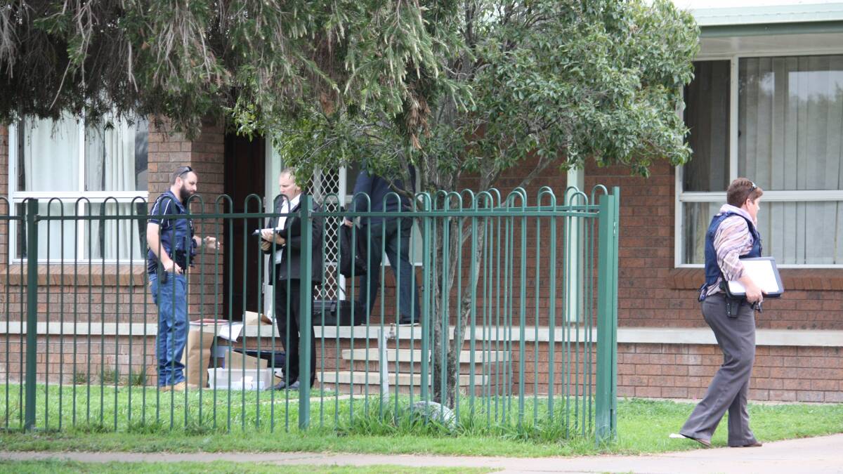 ROLLING RAIDS: Strike Force Burril detectives outside a Gunnedah home which was searched as part of the police operation. Photo: Vanessa Honke