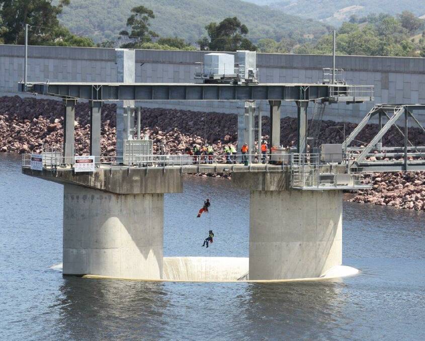 Emergency exercise: Two rescuers abseil down the morning glory spillway at Chaffey Dam on Tuesday morning as part of the training operation between Ambulance NSW and the SES. Photo: State Emergency Service