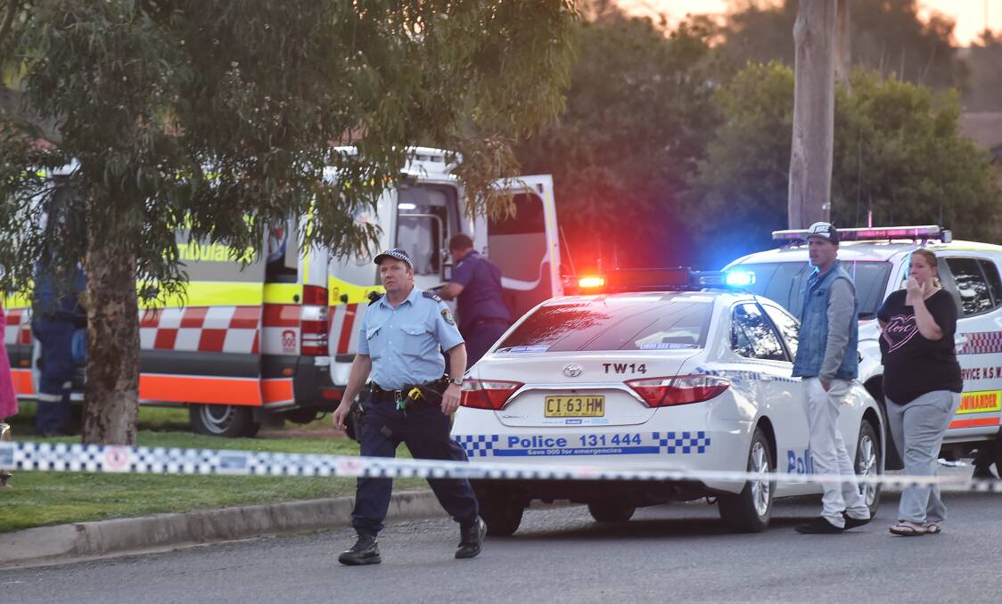 Charges laid: Police set up an exclusion zone around Glen St and Sue Cr on Wednesday afternoon as witnesses look on. Photo: Gareth Gardner 170816GGC02