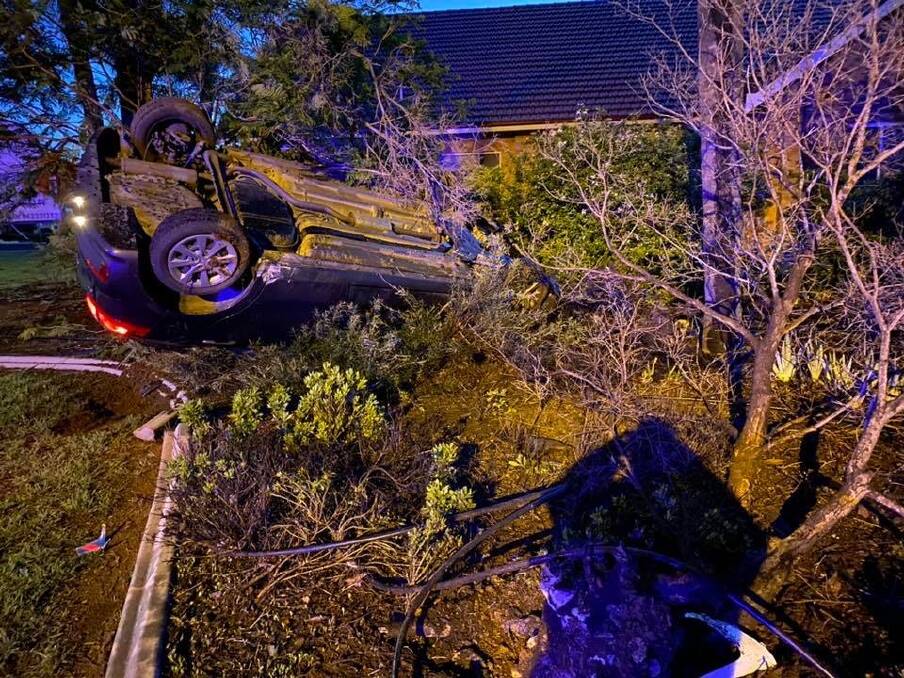 Police manhunt: This stolen Kia crashed and rolled into a frontyard of a Church Street home in South Tamworth overnight on Monday after a police pursuit. Photo: Fire and Rescue NSW West Tamworth