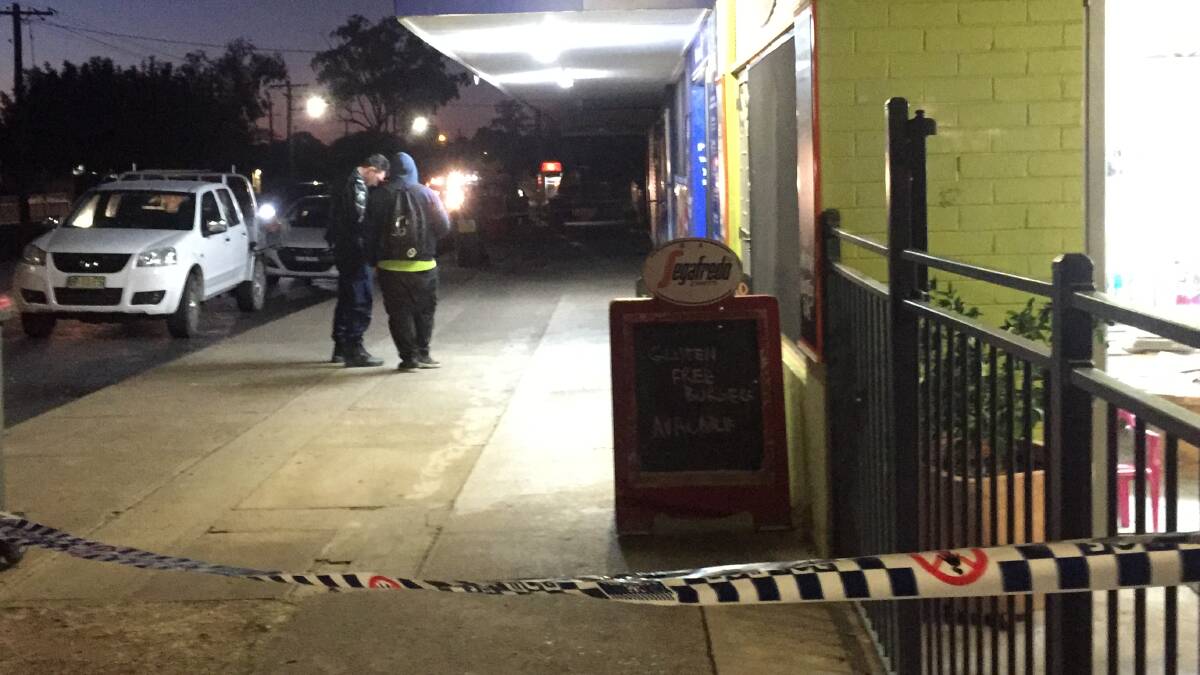 Crime scene: Police speak to witnesses out the front of the Hillvue Superette on May 21. Photo: Gareth Gardner