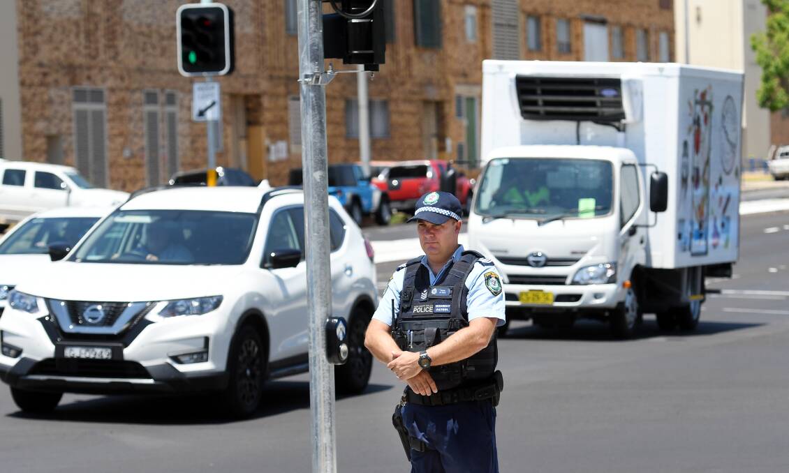 Warning: Oxley Sergeant Michael Buko at the new traffic lights on Marius and Fitzroy streets in Tamworth. Photo: Gareth Gardner 290119GGB05