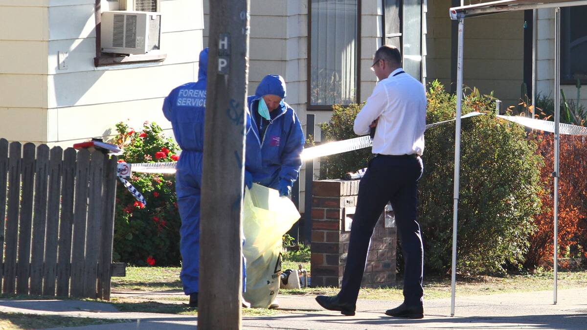 Crime scene: Forensic police and a detective in Robert Street as officers canvassed the neighbourhood on Thursday. Photo: Breanna Chillingworth