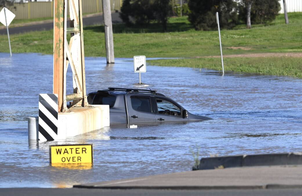 Traffic was thrown into chaos while roads, paddocks and sporting fields went underwater after flooding rains. Pictures by Gareth Gardner