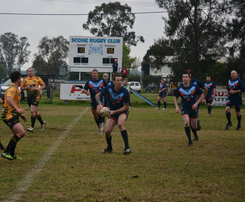 Good cause: Cods' Adam Splintoff, pictured centre, looks to offload as Oxley charge to the line in the first half.