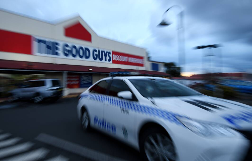 Crime scene: Police and detectives at the store in the Longyard area on June 28.  Photo: Gareth Gardner