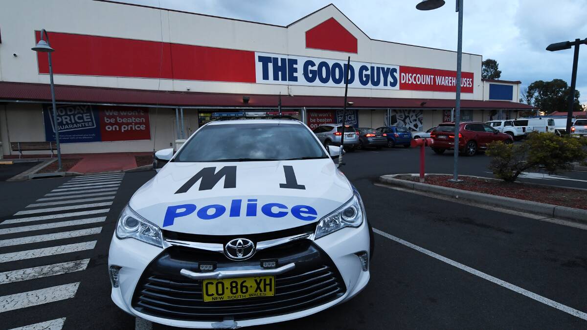Crime scene: Police and detectives at the store in the Longyard area on Thursday afternoon. Photos: Gareth Gardner