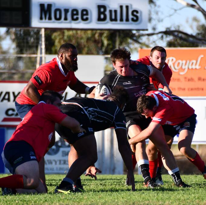ON ATTACK: Dan Coulthurst had a good game for Moree against Walcha on Saturday. Here he is pictured getting tackled by Gunnedah players. Moree will face the Red Devils this coming Saturday.