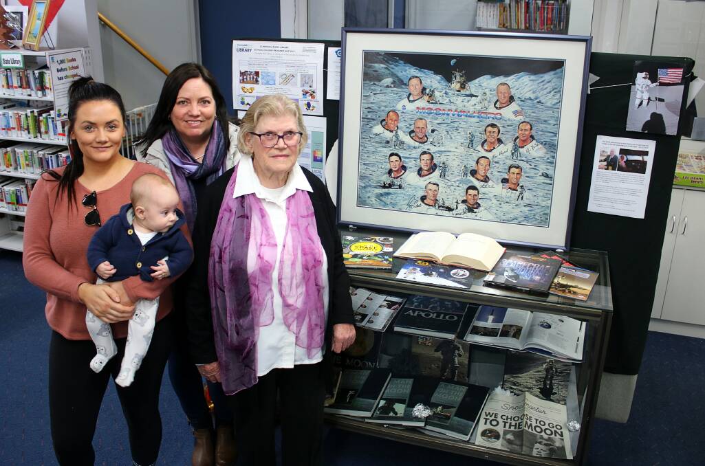 AVID COLLECTOR: Items from the late David Newell's collection on display at Gunnedah Shire Library. Pictured are Mr Newell's niece Gabrielle Wales with her son Wren, his sister Jennifer Warner, and his mother Rose Newell. 
