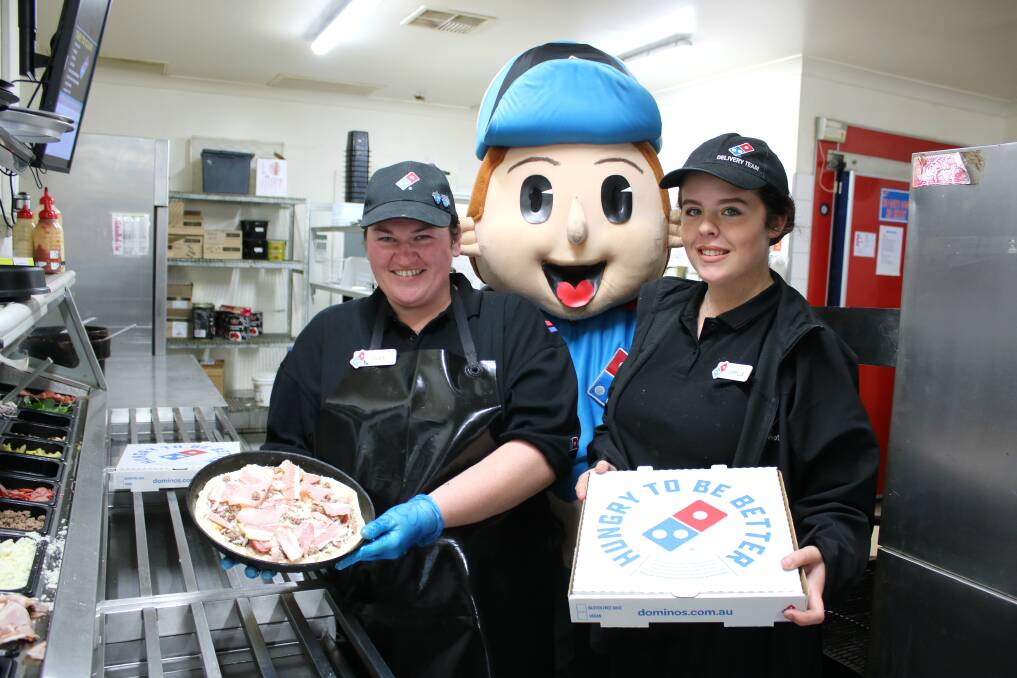 Domino's Gunnedah store manager Jamie Small, Keegan Hall in the mascot suit, and Camilla Brett.