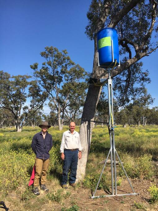 University of Sydney's Elliot Webb with Robert Frend, "Dimberoy" landholder and inventor of the wildlife water drinker dubbed the Tree Troff (top, right).