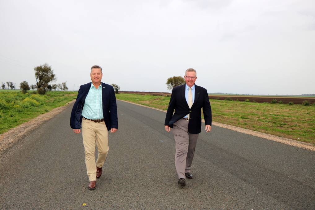 SAFER ROAD: Gunnedah shire mayor Jamie Chaffey and Parkes MP walk the new tar on the Mullaley end of the Grain Valley Road.