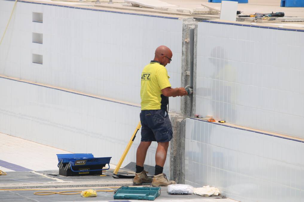 A contractor working on the movement joint in the 50m pool on Monday.