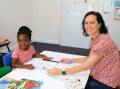 Pre-schooler Joy Chavula and learning support teacher Amy Marmara in the new Rainbow Room.
