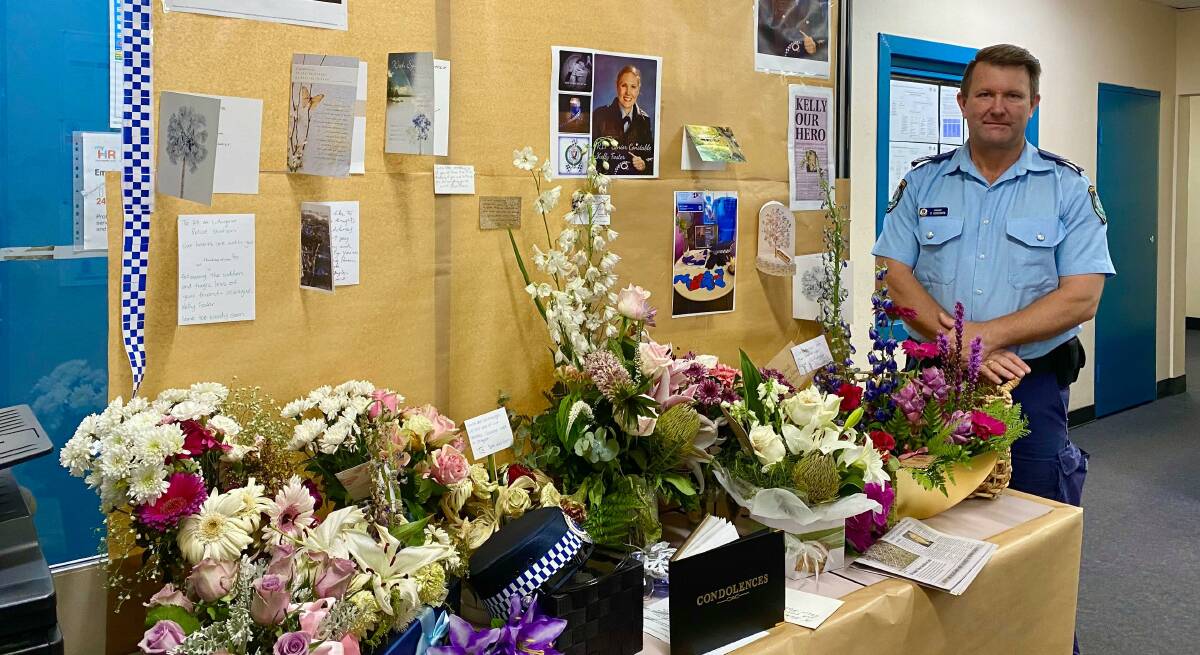 REMEMBERED: Sergeant Darryl Goodwin of Lithgow Police with the station's tribute to Senior Constable Kelly Foster. Photo: ALANNA TOMAZIN