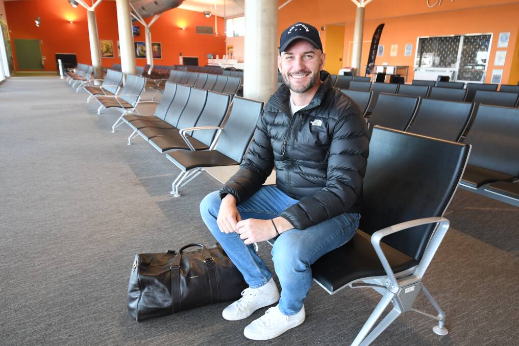 FLYING SOLO: Ben Webb waits in an empty Orange airport terminal to fly to Tamworth. Photo: JUDE KEOGH