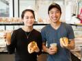 Rutherford's M&M Bakehouse owners Melissa Do and Patrick Vu with a traditional Banh Mi and a crispy Banh Mi, and Vietnamese iced coffees. Photo: Max Mason-Hubers