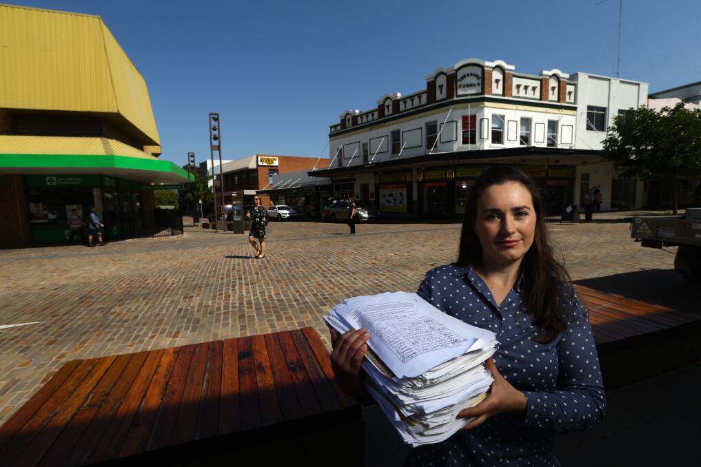 PETITION: Maitland Mercury journalist Belinda-Jane Davis with the pile of signatures that will be tabled in NSW Parliament. Picture: Jonathan Carroll.