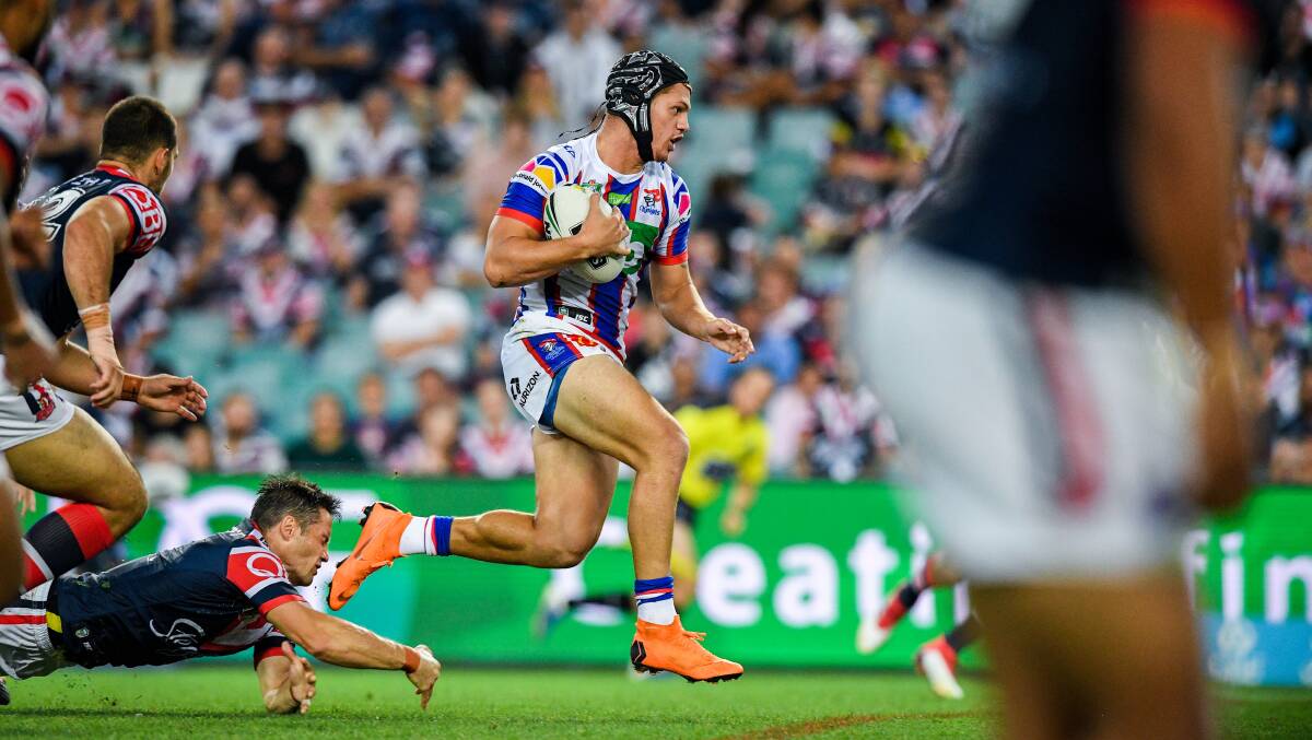 CLEAN PAIR OF HEELS: Kalyn Ponga leaves Cooper Cronk in his wake during Newcastle's recent clash with the Roosters. Picture: AAP