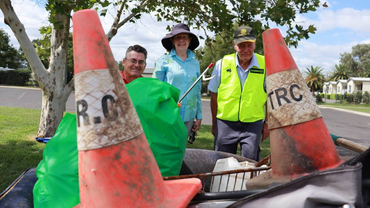 COUCH SURFING: McCarthy Catholic College's Shaun Nichols, Rotary Club Of Tamworth First Light's Anne Jacobs and Richard Walker with their rubbish 'loot' on the couch. Photo: Jacinta Dickins