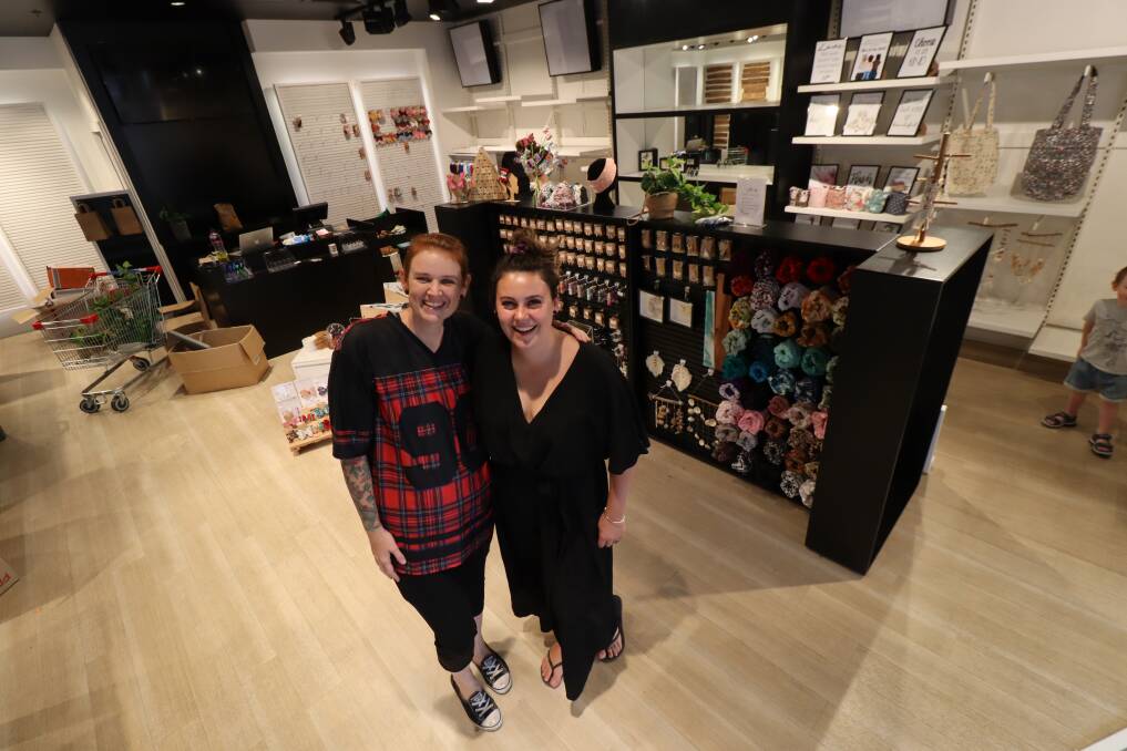 GETTING READY: Two Little Sisters Handmade Collective collaborator Nicole Jones with business owner Tori Brickell busily stocking shelves readying the store on Peel Street. Photo: Jacinta Dickins