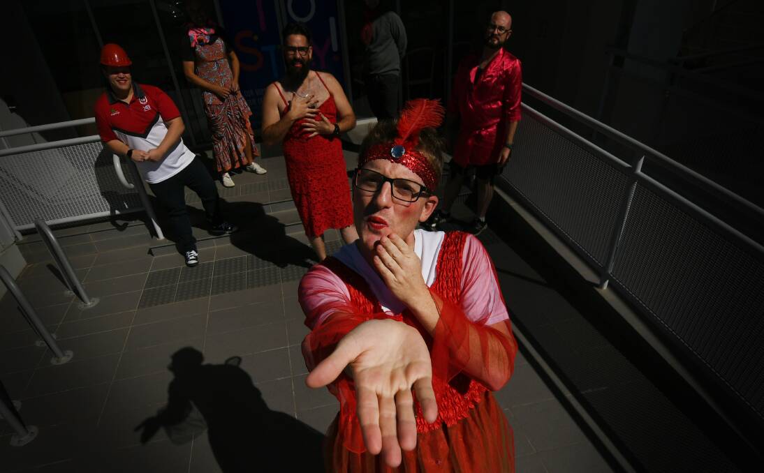 SEE RED: Joblink Plus' Tim Diebold blew a kiss goodbye to MS, joined by other team members in red drag for the fundraiser. Photo: Gareth Gardner