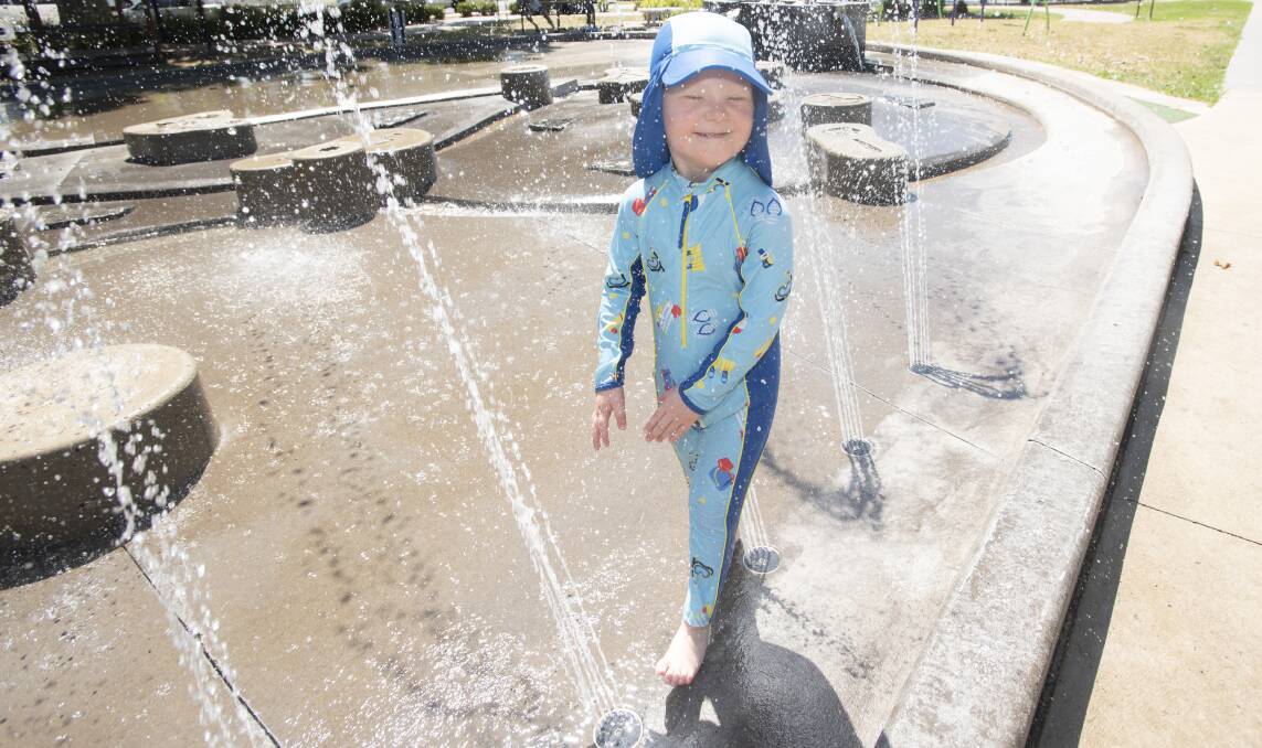 COOL IT: Thomas Brady keeping cool at Tamworth's splash pad in Bicentennial Park. Photo: Peter Hardin