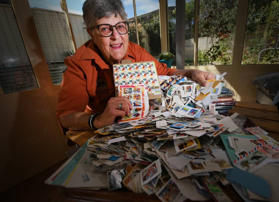 VALUE: Peel Valley Lions Club member Anne Sanders collects stamps to auction for charity, and says not many know the value of what they have. Photo: Gareth Gardner.